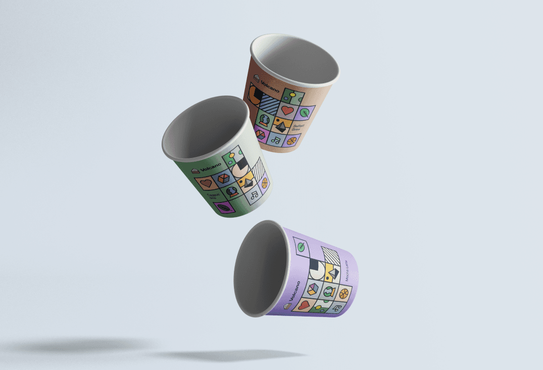 Three takeaway cups in peach, sage and lilac, tumbling in mid-air, each with its own arrangement of tiles.